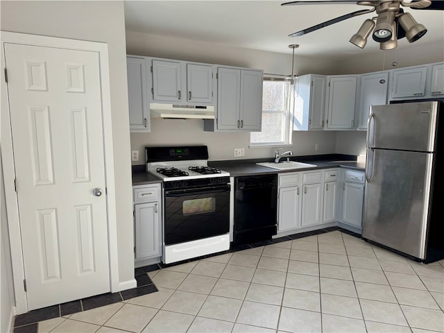 kitchen featuring gas range gas stove, sink, dishwasher, stainless steel refrigerator, and light tile patterned flooring