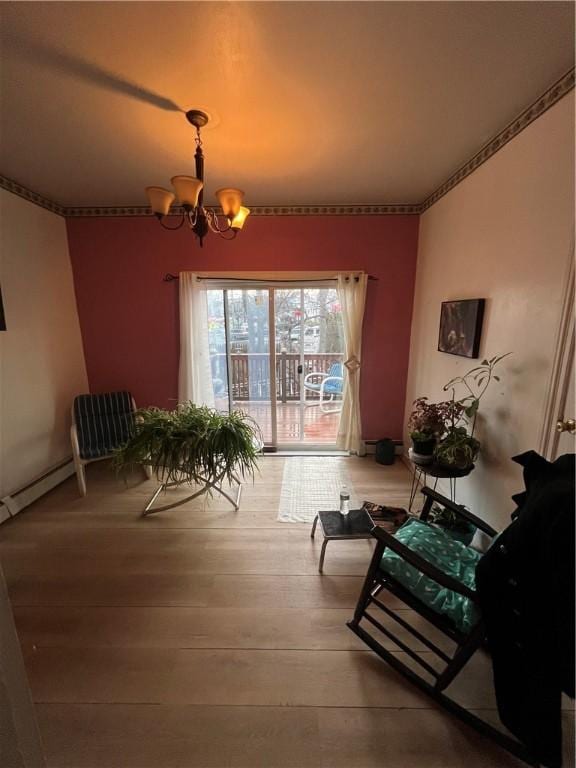 dining room with baseboard heating, a chandelier, and wood-type flooring