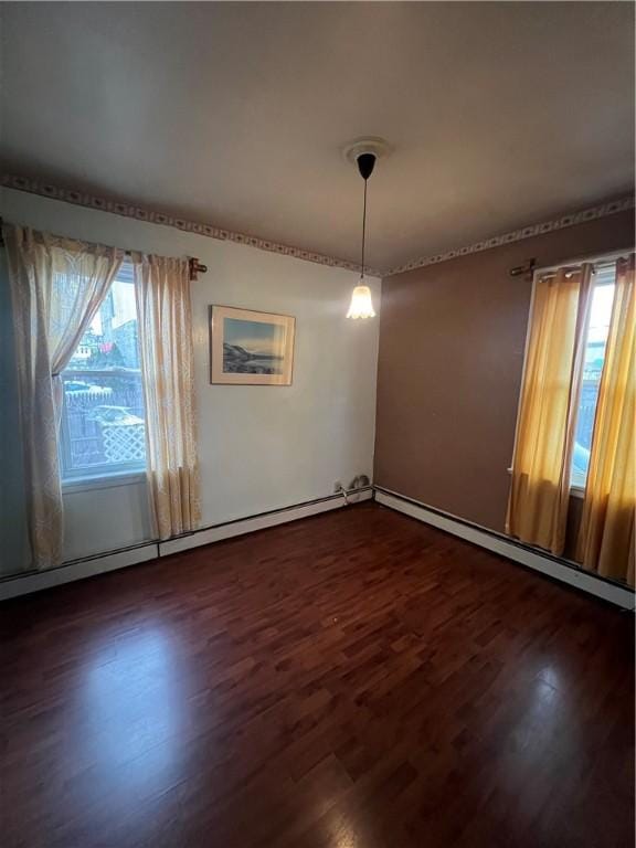 unfurnished dining area with a wealth of natural light, dark hardwood / wood-style flooring, and a baseboard radiator