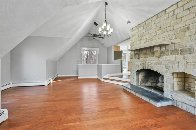 unfurnished living room featuring ceiling fan with notable chandelier, a large fireplace, baseboard heating, wood-type flooring, and lofted ceiling