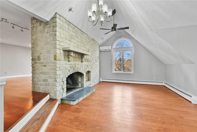 unfurnished living room with a wall mounted air conditioner, a brick fireplace, ceiling fan with notable chandelier, vaulted ceiling, and wood-type flooring