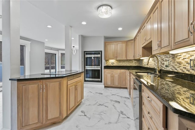 kitchen featuring decorative backsplash, stainless steel appliances, dark stone countertops, and sink