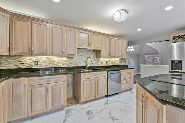 kitchen featuring light brown cabinets, sink, decorative backsplash, dark stone countertops, and appliances with stainless steel finishes