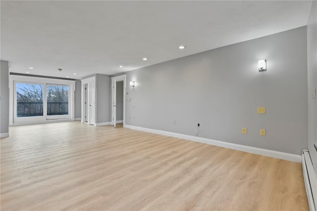 unfurnished living room with light wood-type flooring and a baseboard radiator