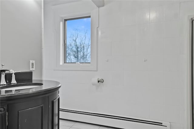 bathroom with tile patterned floors, vanity, and a baseboard radiator