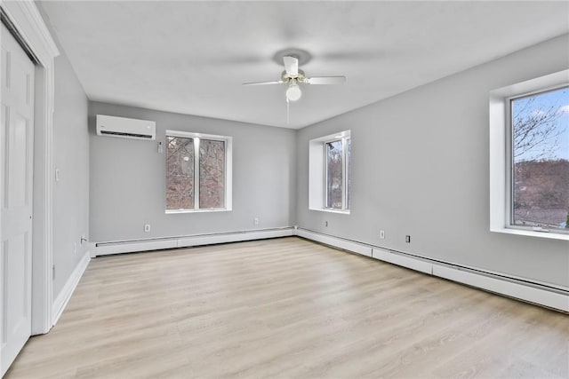 unfurnished room featuring a wall mounted air conditioner, a wealth of natural light, a baseboard heating unit, and ceiling fan