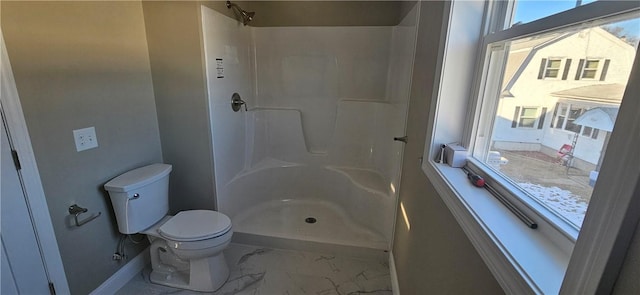 bathroom featuring toilet and walk in shower