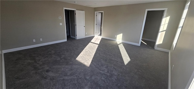 empty room featuring dark carpet