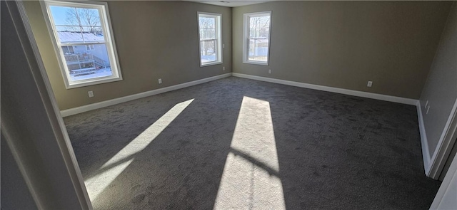 unfurnished room featuring dark carpet