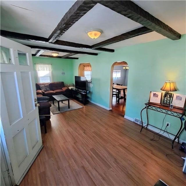 living room with beam ceiling and hardwood / wood-style flooring