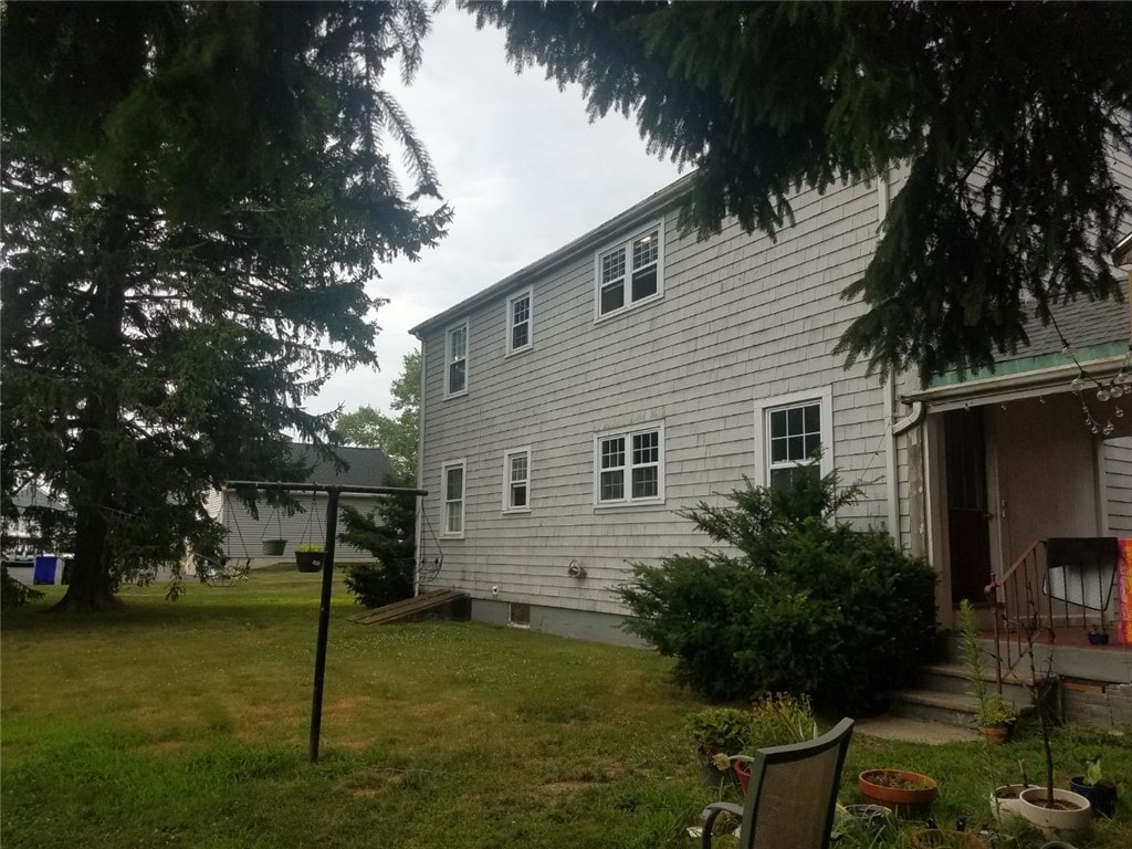 view of side of property with a lawn