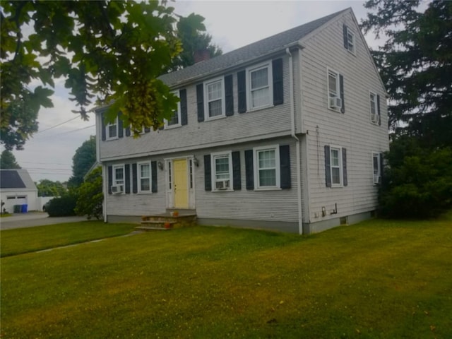 colonial-style house featuring a front lawn