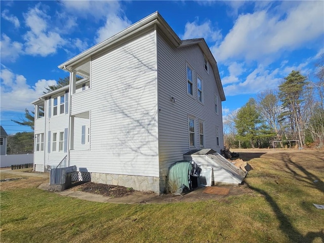 view of home's exterior with a lawn