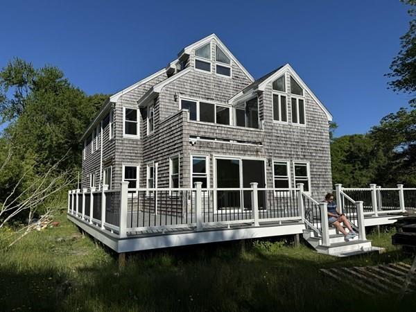 back of property featuring a wooden deck