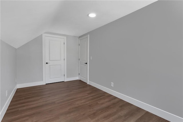 bonus room featuring dark hardwood / wood-style flooring and vaulted ceiling