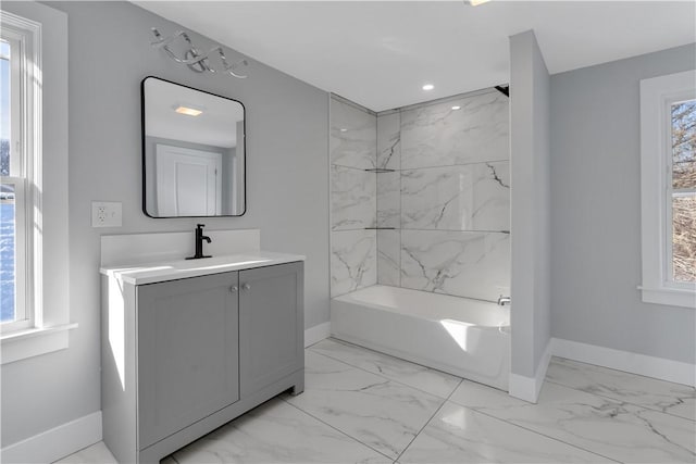 bathroom featuring vanity and tiled shower / bath