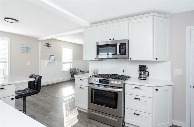 kitchen featuring white cabinets, light hardwood / wood-style floors, and appliances with stainless steel finishes