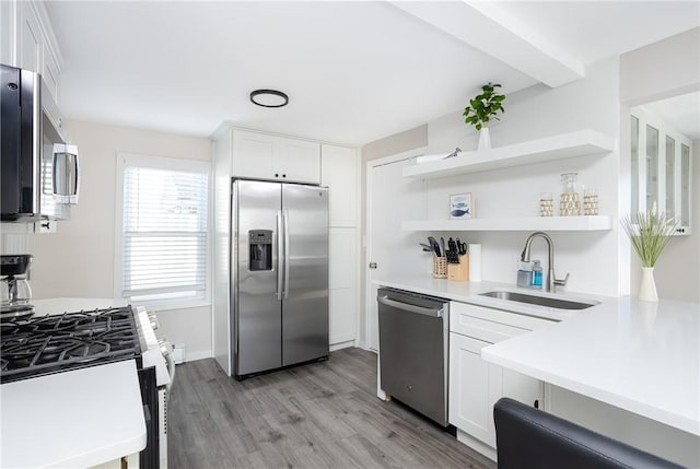 kitchen with light hardwood / wood-style flooring, stainless steel appliances, white cabinetry, and sink