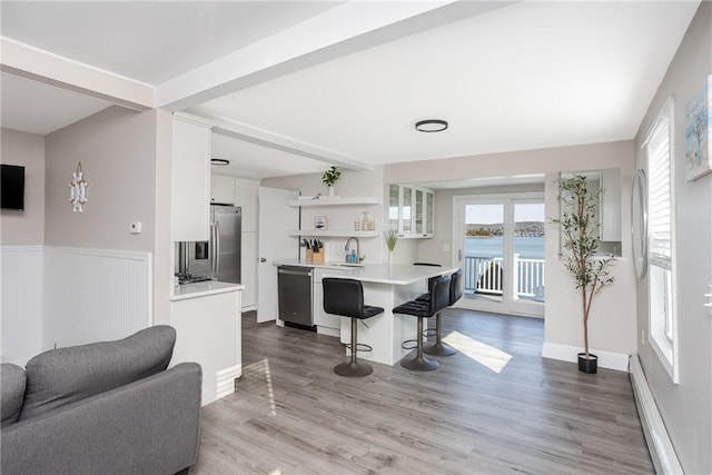 kitchen with sink, white cabinets, stainless steel appliances, and plenty of natural light