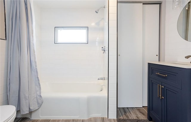 full bathroom featuring vanity, shower / bath combination with curtain, and toilet