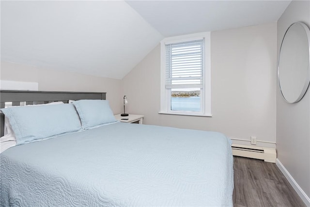 bedroom with dark hardwood / wood-style flooring, vaulted ceiling, and baseboard heating