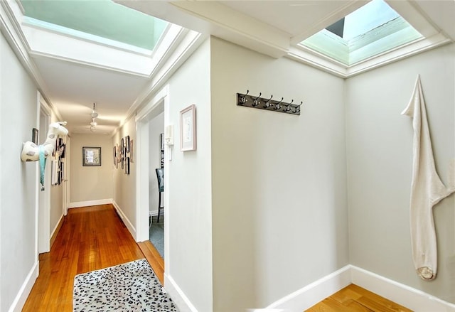 corridor with crown molding and hardwood / wood-style floors