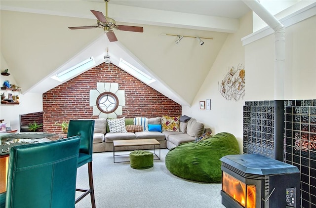 living room featuring ceiling fan, carpet floors, lofted ceiling with beams, and rail lighting