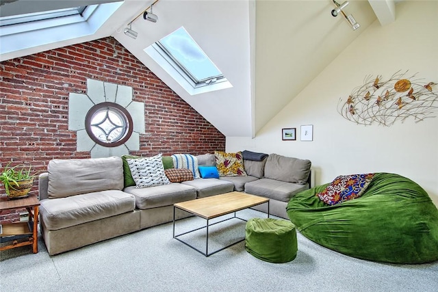 living room featuring carpet flooring, rail lighting, vaulted ceiling with skylight, and brick wall