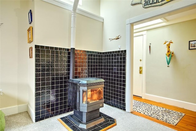 bathroom featuring a wood stove and tile walls