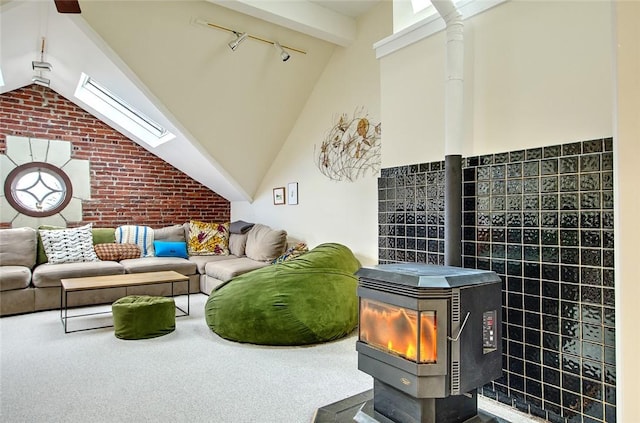 carpeted living room featuring rail lighting and high vaulted ceiling