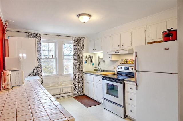 kitchen with stainless steel range with electric stovetop, tile countertops, a baseboard radiator, white fridge, and white cabinetry