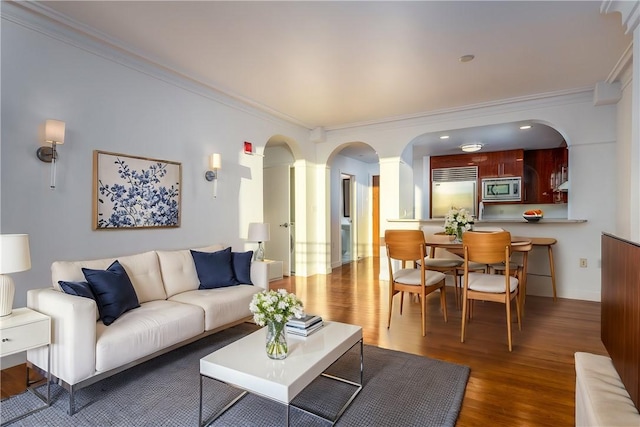 living room with crown molding and dark hardwood / wood-style floors