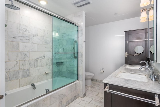 full bathroom with vanity, combined bath / shower with glass door, and toilet