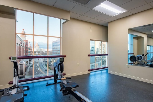 gym with a paneled ceiling