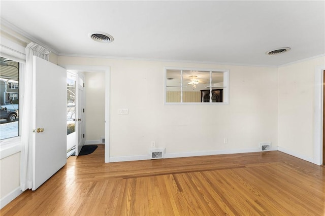 spare room featuring hardwood / wood-style floors and ornamental molding