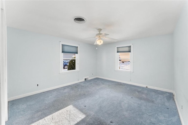 carpeted spare room with ceiling fan