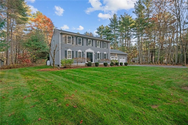 colonial-style house with a garage and a front lawn