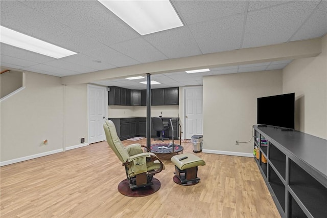 sitting room with hardwood / wood-style flooring and a paneled ceiling