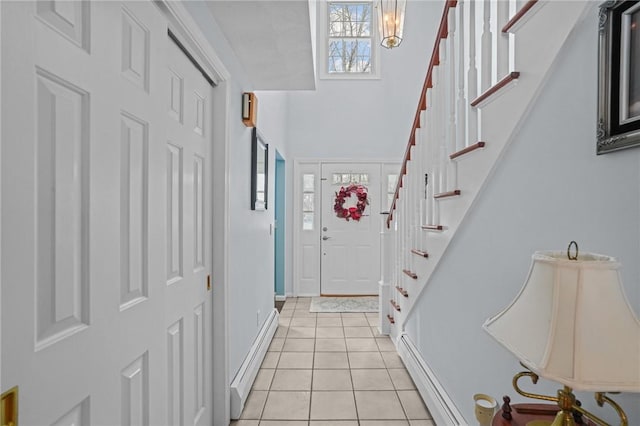 entrance foyer with light tile patterned flooring and a baseboard heating unit