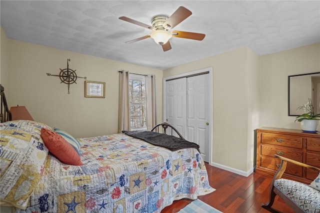 bedroom with dark hardwood / wood-style floors, a closet, and ceiling fan