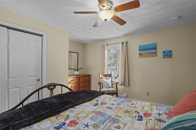 bedroom featuring a baseboard radiator, a closet, and ceiling fan