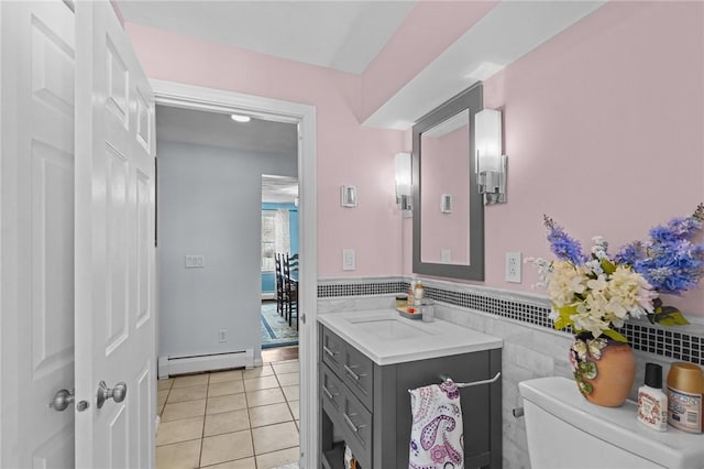 bathroom with tile patterned floors, toilet, tile walls, a baseboard radiator, and vanity