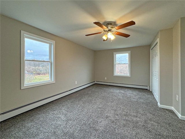 carpeted spare room featuring ceiling fan and a baseboard radiator