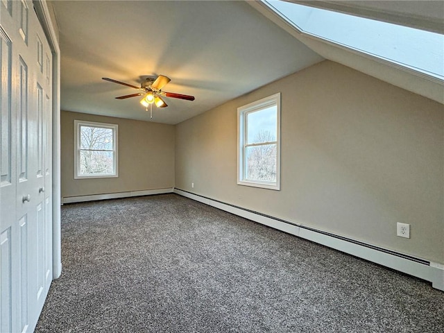 bonus room with vaulted ceiling with skylight, ceiling fan, and a wealth of natural light