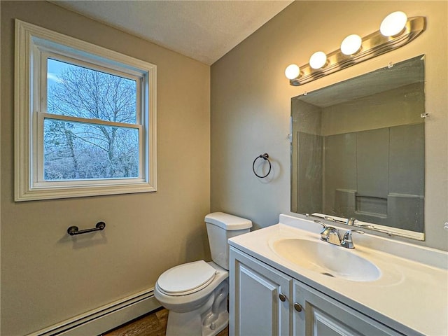 bathroom featuring a textured ceiling, vanity, a baseboard radiator, and toilet