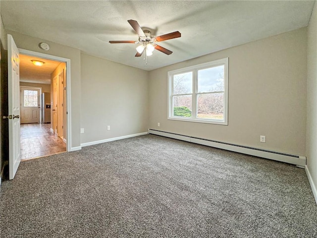 carpeted spare room featuring a textured ceiling, ceiling fan, and baseboard heating