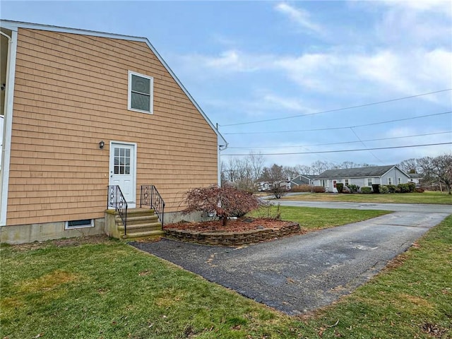 view of home's exterior featuring a lawn