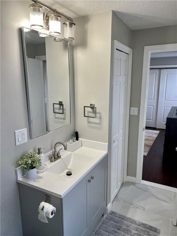 bathroom featuring vanity and a textured ceiling