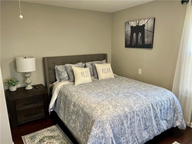 bedroom with dark hardwood / wood-style flooring