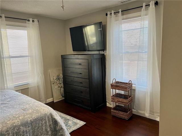 bedroom with dark wood-type flooring